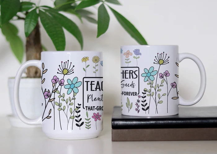 Teaching in Full Bloom white ceramic coffee mug featuring colorful whimsical flowers and a teacher-inspired message about planting seeds that grow, available in 11 oz and 15 oz sizes.