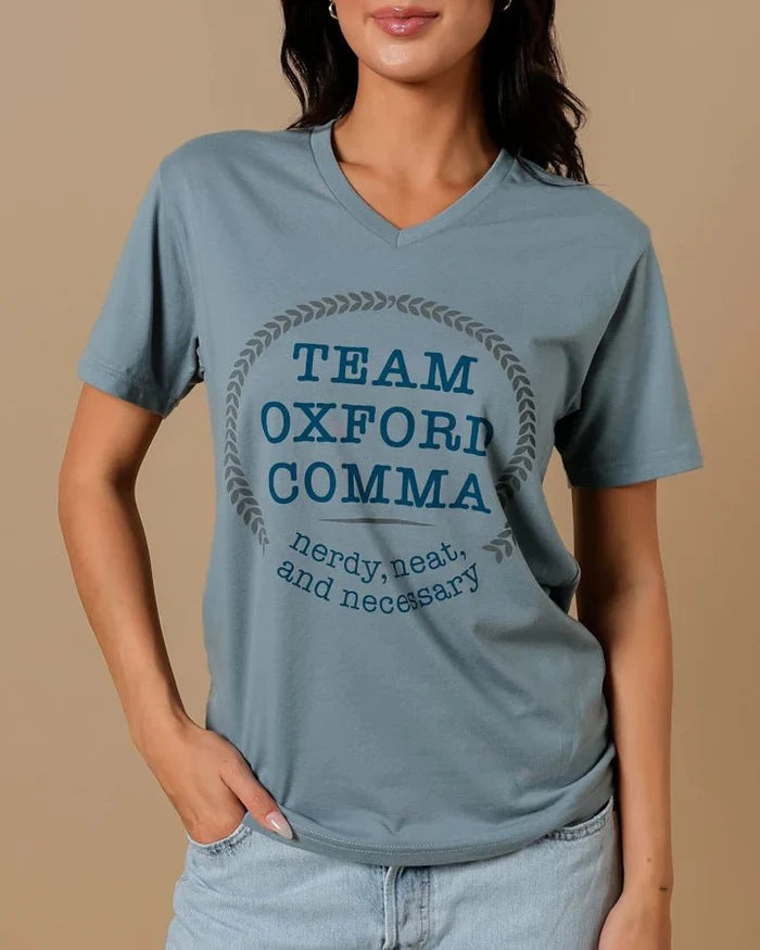 Team Oxford Comma Shirt is a dusty blue v-neck shirt that reads: "Team Oxford Comma | nerdy, neat, and necessary"
