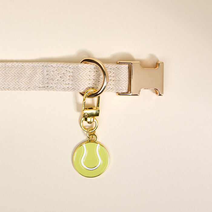 Add playful pet style with The Darling Effect's Tennis Ball Pawfect Collar Charm—a gold keychain charm shaped like a green tennis ball, perfect for pairing with your favorite collar accessories.