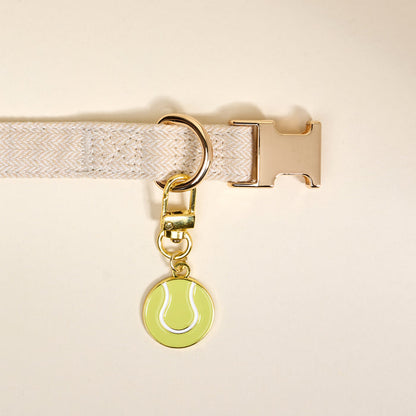 Add playful pet style with The Darling Effect's Tennis Ball Pawfect Collar Charm—a gold keychain charm shaped like a green tennis ball, perfect for pairing with your favorite collar accessories.