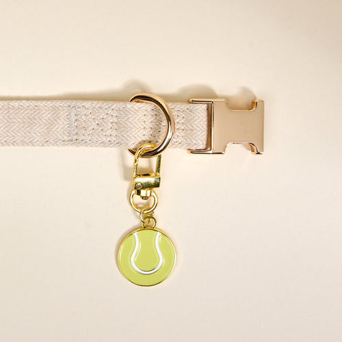Add playful pet style with The Darling Effect's Tennis Ball Pawfect Collar Charm—a gold keychain charm shaped like a green tennis ball, perfect for pairing with your favorite collar accessories.