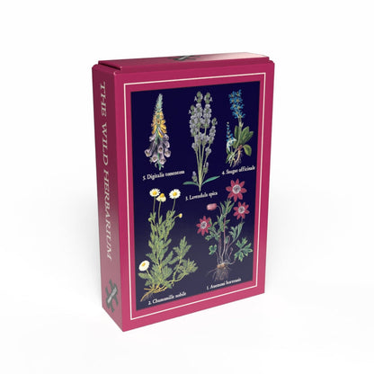 The Wild Herbarium | 99 Piece Jigsaw Puzzle by Penny Puzzle comes in a pink box featuring vintage botanical art of five flowering plants with scientific names—a charming minipuzzle perfect for plant lovers.