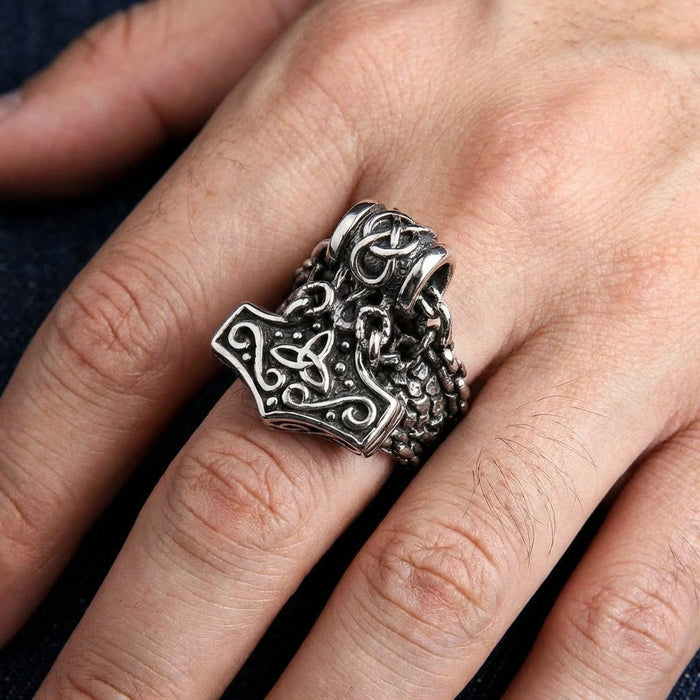 Man wearing Thor's Hammer Mjolnir sterling silver ring on finger showing scale and fit