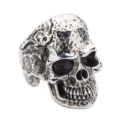 A side view of the sterling silver skull ring, highlighting the deep, organic texture across the cranium.