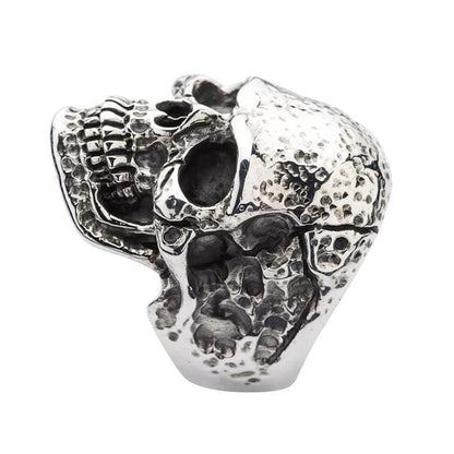 A detailed shot focusing on the deeply oxidized teeth and jawline of the tough head skull ring.