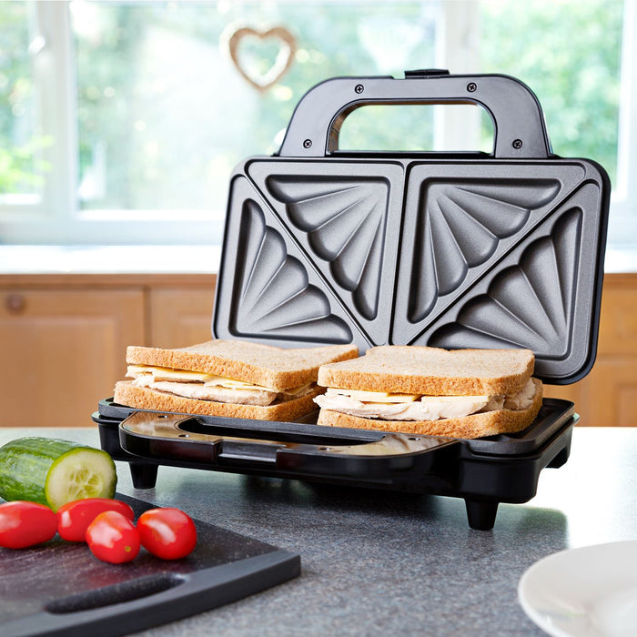 Gray sandwich maker with two sandwiches on a kitchen counter - Buy Now Deep Fill Sandwich Toaster + Round Waffle Maker