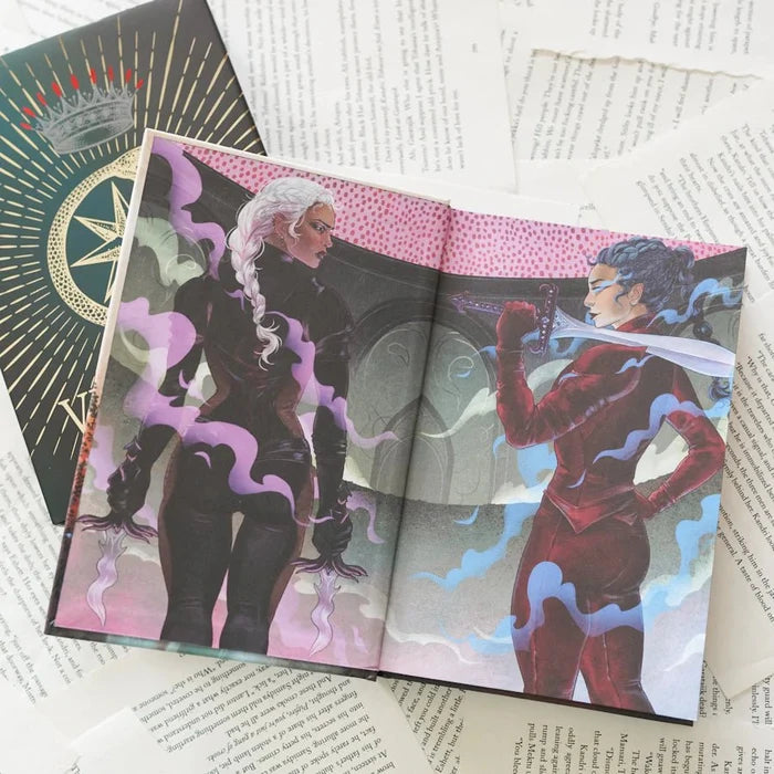 This image shows an open book with two illustrations of characters on facing pages. The left page depicts a character with long white hair wielding a sword, while the right page shows another character with dark hair also holding a sword. The book is placed on top of several sheets of paper with printed text. The background includes a decorative cover with a crown and star symbol on the top left. The illustrations have a fantasy theme with dynamic poses and dramatic expressions.