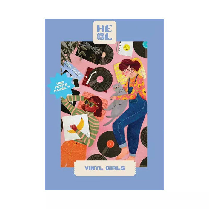 Vinyl Girls | 99 Piece Jigsaw Puzzle by Heol Editions features two women on a pink floor with vinyl records, cat, books, and headphones. Blue border reads "Vinyl Girls" and "Heol". Perfect mini puzzle for retro fans.