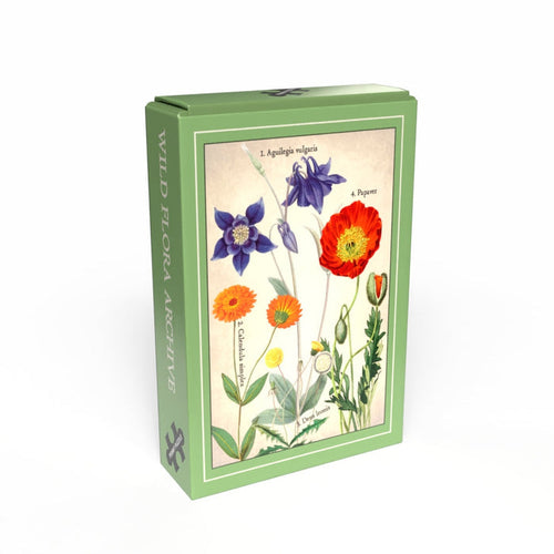 The Penny Puzzle Wild Flora Archive is a green box with botanical wildflower illustrations, including poppies and columbines, on the front, containing a vintage-style 99 piece jigsaw puzzle inside.