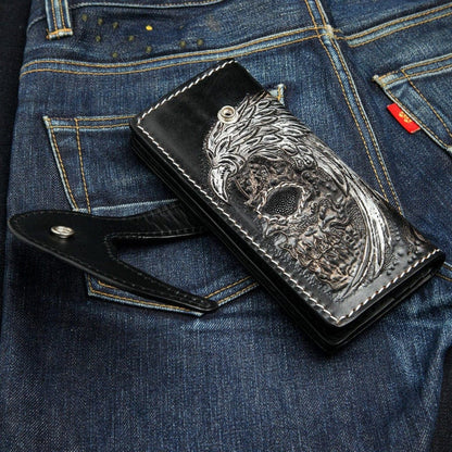 Winged skull wallet with snap closure open showing carved leather eagle feather details and stingray face inlay